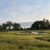 A view of a green protected by strategically placed bunkers at University of Michigan Golf Course.