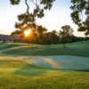 A sunny day view of a hole at Huron Hills Golf Course.