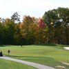 A view of green with narrow road on the left at Twin Lakes Golf Club