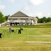 A view of the driving range and clubhouse in background at Willow Wood Country Club