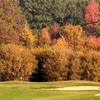 A fall view of green protected by bunkers at Willow Wood Country Club