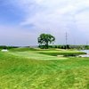 A view from fairway #18 of the green surrounded by water at Crown Golf Course