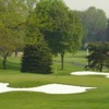 A view of a green protected by a collection of sand traps at Country Club of Lansing