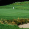 A view of a hole protected by a bunker at Calderone Golf Club