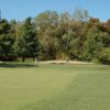 A view of a green protected by tricky bunkers at Fox Creek Golf Course