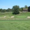 A view of a green flanked by bunkers at Plum Hollow Country Club
