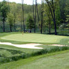 A view of green with two carts in background at Gull Lake View Golf Course - Stonehedge NorthGolf Course