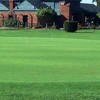 A view of the putting green with clubhouse in background at Chandler Park Golf Course 