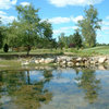 A view of green surrounded by water atRichmond Forest Golf Club 