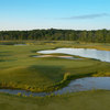 A view of a green surrounded by water at Devil's Ridge Golf Club