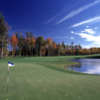 A view of a hole guarded by fall trees at Black Lake Golf Club