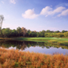 View of a green and bunker at Lyon Oaks Golf Club