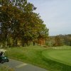 A fall view with golf cart in foreground from Mystic Creek Golf Club
