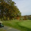 A fall view with golf cart in foreground from Mystic Creek Golf Club