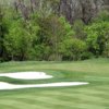 A spring view of a hole surrounded by sand traps at Monroe Golf & Country Club