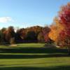 A fall day view of a green flanked by bunkers at Sugar Springs Golf Course