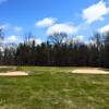 A view of a green protected by bunkers at Red Fox Run Golf Course