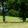 A view of a green protected by a bunker at Klinger Lake Country Club
