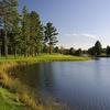 The sixth hole on the Reflections Course at Garland Lodge & Resort is bordered by a large pond to the right with bunkers protecting the right front and back of the green.