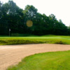 A view of a hole protected by a manicured bunker at Thoroughbred Golf Club.