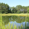 A sunny day view of a hole at Whitefish Lake Golf Club.