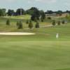 A sunny day view of a hole at Red Oaks Golf Course.