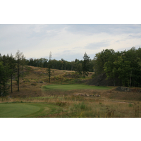 The 15th hole at Greywalls Golf Course is a long par 3 over a ravine to a wide green.