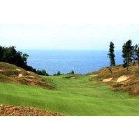 The 11th hole at Arcadia Bluffs Golf Club, a par 5 that plays more than 600 yards, slopes toward Lake Michigan.