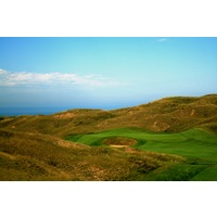 A massive bunker guards the front of the 10th green at Arcadia Bluffs Golf Club.