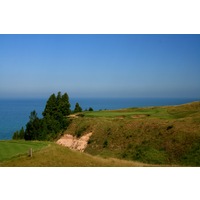 The par-3 13th hole at Arcadia Bluffs Golf Club plays over a valley and beside Lake Michigan. 