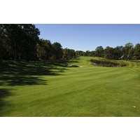 The ninth hole on the Fountains Course at Garland Lodge and Resort is a short par 3 with a lake in front of the green. 