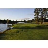 The tight 12th hole on the Monarch Course at Garland Lodge and Resort features mature pines along either side and water to the left. 