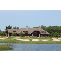 The par-3 ninth holes at Forest Dunes Golf Club sits in the shadow of the clubhouse.